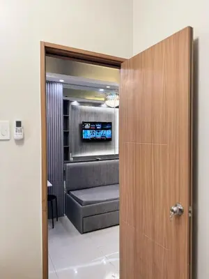 a room with a couch and a tv in a room at Milagrosa Shore 3 residences in Manila