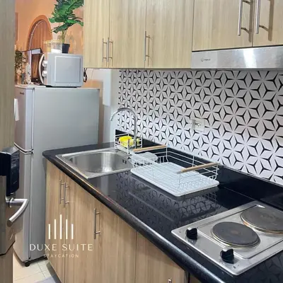 a kitchen counter with a sink and a refrigerator at Cozy Vibes near Moa & Naia Airport Wifi Netflix-Duxe8 in Manila