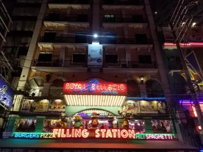 a building with neon signs on it at night at Downtown Makati Malls and Bars at your doorsteps in Manila