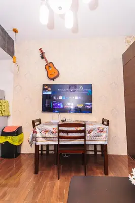 a dining room table with a guitar on the wall at Eccentric Escape Stylish Makati Urban Swim Gym 4034 in Manila
