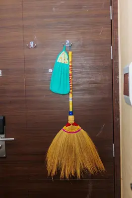 a broom and a bag hanging on a door at Boutique Air Retreat Relax Laugh Swim Gym Car Park 1767 in Manila