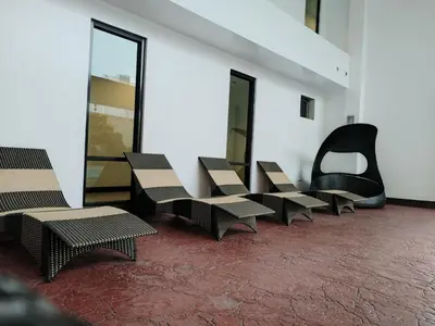 a row of chairs and tables in a building at Casa Makati in Manila
