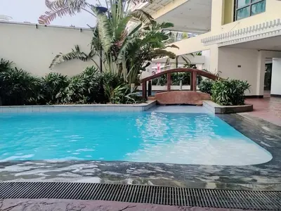 a large swimming pool in a building with plants at Casa Makati in Manila