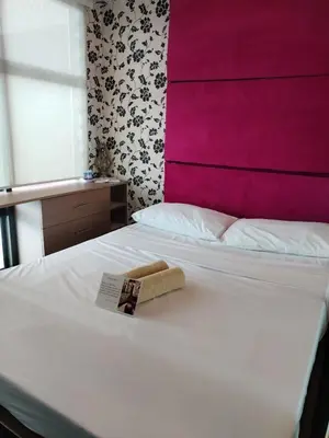 a hotel room with a towel on a bed at Casa Makati in Manila