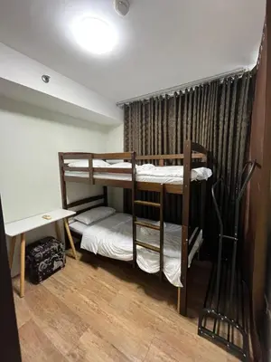 a room with two bunk beds and a desk at The Serenity Tower 2706 in Manila