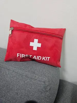 a red first aid kit sitting on top of a couch at Happy Home Haven At S Residences Moa in Manila