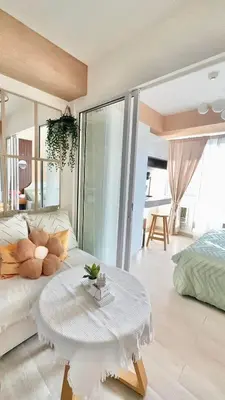 a living room with a white couch and a table at Serene Cove Azure in Manila