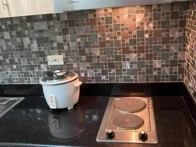 a coffee maker sitting on top of a stove in a kitchen at ren&ayesha place in Manila