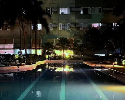 a swimming pool at night in front of a building at 2BR Condotel Ridgewood Tower Taguig in Manila