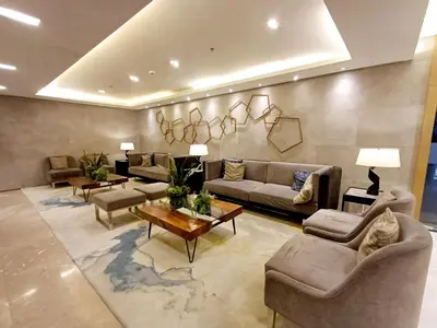 a large living room with couches and a table at S Residences 942b near airport pasay in Manila