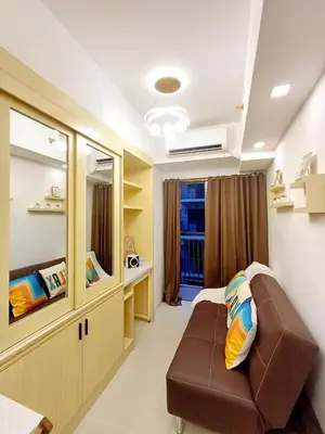 a hospital room with a couch and a mirror at S Residences 942b near airport pasay in Manila