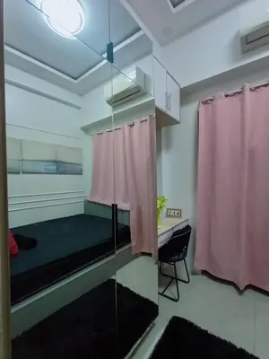 a room with a bed and a pink curtain at Shore residence Tower D moa ecom view cozy bedroom in Manila
