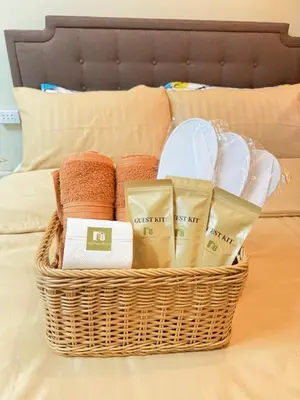 a basket of towels and towels on a bed at D88Staycations 105- Condo Staycation beside Enchanted Kingdom in Santa Rosa