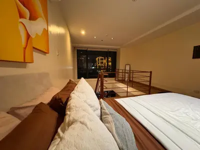 a bedroom with a bed and a view of a building at Gramercy Residences Spacious 1 BR Loft FREE Amenities in Manila