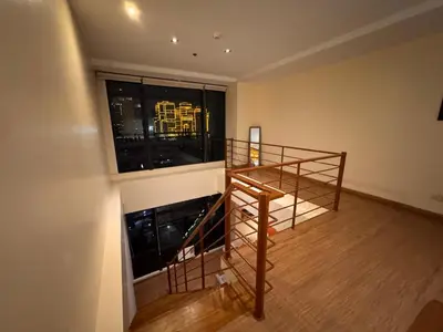 a room with a staircase and a large window at Gramercy Residences Spacious 1 BR Loft FREE Amenities in Manila