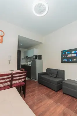 a living room with a couch and a table at The Quirk Inn Air residence Makati Swim Gym Park Eat Laugh 3301 in Manila