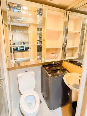 a small bathroom with a toilet and a sink at 907 Air Condo Urban Retreat 1BR w City View MOA in Manila