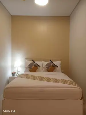 a bedroom with a large bed with two pillows at Happystaywithus in Manila