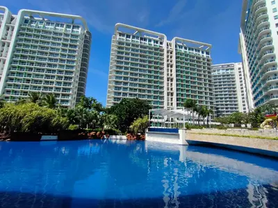 a pool in front of two tall buildings at Azure's Best by Condo Suites PH in Manila