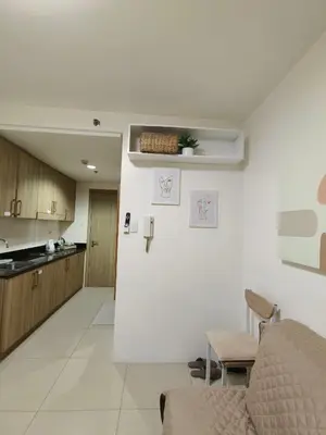 a kitchen and a living room with a couch and a table at Barkada Room by Metro Staycation in Manila