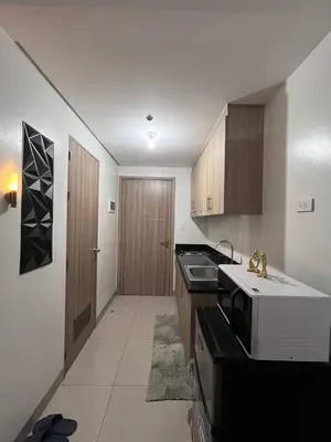 a kitchen with a sink and a microwave at Couple or Barkada Room in Manila