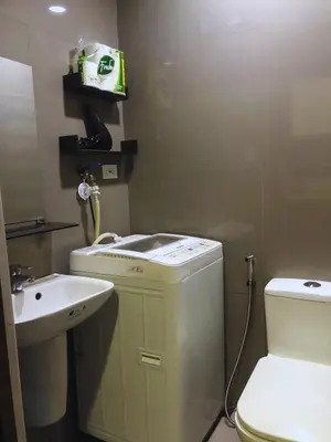 a small bathroom with a sink and a toilet at Modern Style and Family Friendly in Manila