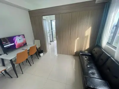 a living room with a couch and a table at Shore 2 Residences MOA NAIA in Manila