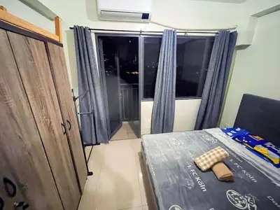 a small room with a bed and a window at shore 2 tower 3 4 floor in Manila