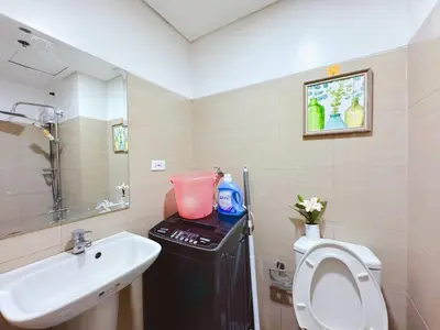 a bathroom with a white toilet and a sink at Shore 1 tower c1 17floor near moa facing swimming pool in Manila