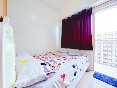 a bed in a white room with a window at Shore 1 tower c1 17floor near moa facing swimming pool in Manila