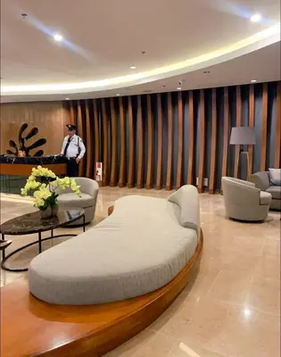 a large bed in a room with a man standing in the background at shore 2 tower 1 19 floor in Manila