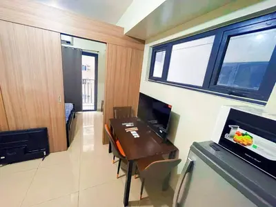 a small room with a dining table and a kitchen at shore 2 tower 2 4 floor in Manila