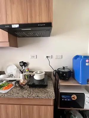 a kitchen with a stove and a counter top at Emmanuel's Lair Prisma Residences in Manila