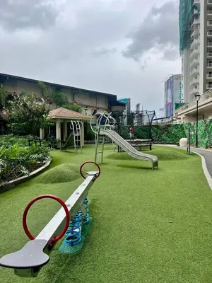 a playground with a slide in a park at Emmanuel's Lair Prisma Residences in Manila