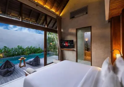a bedroom with a bed and a view of a pool at warda private villa in Pasong Bayog