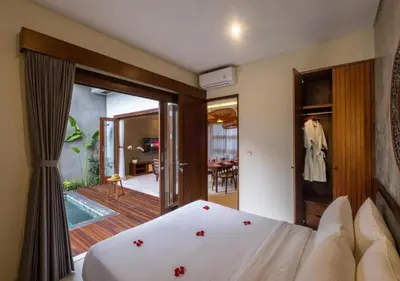 a bedroom with a bed and a sliding glass door at warda private villa in Pasong Bayog