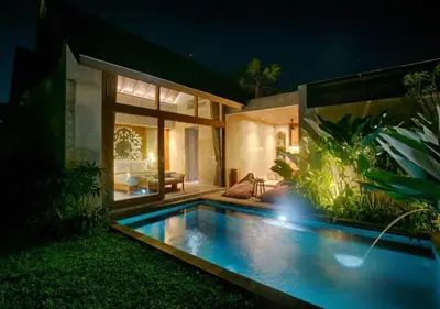 a swimming pool in front of a house at night at warda private villa in Pasong Bayog