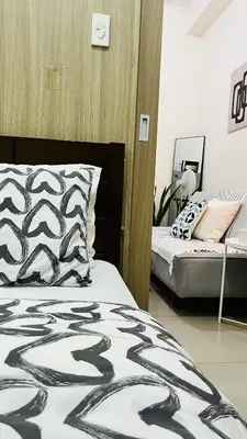 a bedroom with two beds in a room at Direct Access to pool Bedroom in Manila