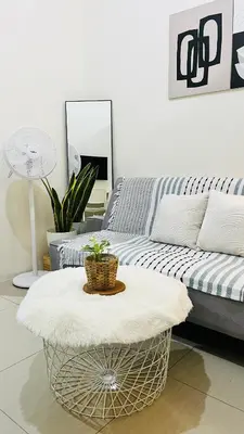 a living room with a couch and a coffee table at Direct Access to pool Bedroom in Manila