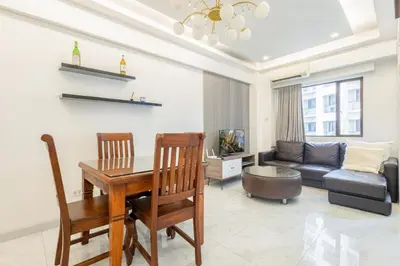 a living room with a table and a couch at Central BGC Forbeswood Heights in Manila