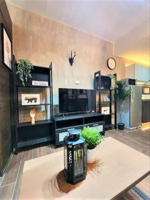 a large living room with a clock on the wall at Air Residences with 500Mbps Wifi in Manila