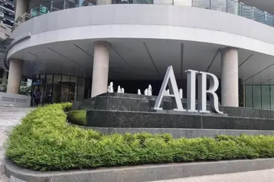 a large building with a sign in front of it at Air Residences with 500Mbps Wifi in Manila