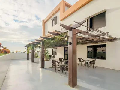 an outdoor patio with chairs and tables on a building at Casa Josefina in Manila