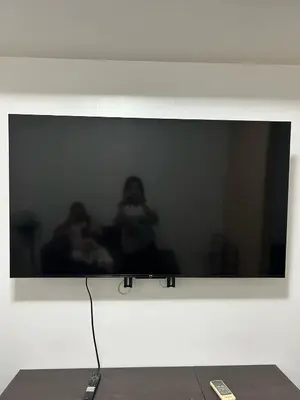 a television screen with a picture of two people at Staycation at MALL OF ASIA -by Tess Ualat in Manila