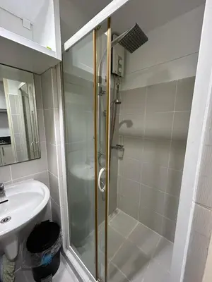 a bathroom with a shower and a sink at Staycation at MALL OF ASIA -by Tess Ualat in Manila