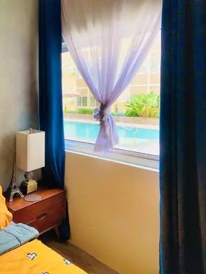 a bedroom with a window with a view of a pool at Cozy Comfy stay, tiny suite in Nuvali, SouthForbes in Silang