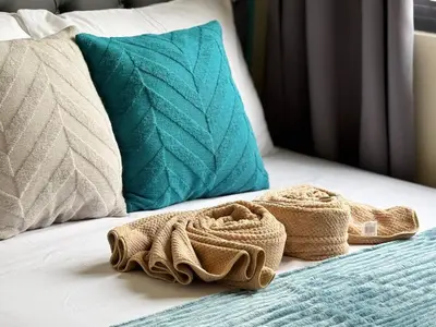 a pair of towels sitting on a bed with pillows at Shore 3 Residences Room 1659 infront of SM MOA in Manila