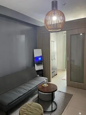a living room with a couch and a table at Bay stays at shore residence in Manila