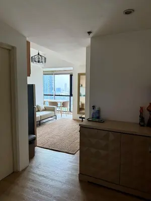 a kitchen and living room with a view of a living room at Condo Roughly 30 mins from NAIA with view of Greenhills in Manila