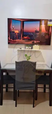 a dining room table with a view of a city at 10th Floor Facing Amenity in Manila